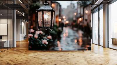   A street light dangles beside a building with pink flowers potted in front Wall mural