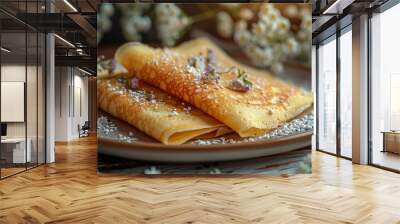   Two crepes on a plate sprinkled with flowers and a vase of flowers nearby Wall mural