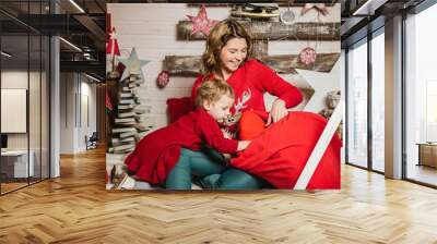 mom and daughter in Christmas red sweaters Wall mural