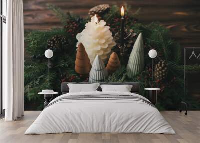 Christmas table setting decor, modern wreath, little trees and candles on rustic wooden table Wall mural