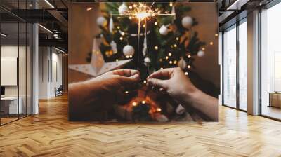 Happy New Year! Couple celebrating with firework lights against christmas tree and glowing star Wall mural