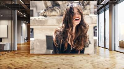 happy stylish woman with gorgeous smile and hair, having fun in sunlight in city street. beautiful h Wall mural