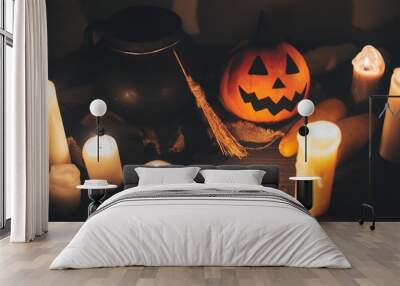 jack o lantern pumpkin with candles, bowl, witch broom and bats, ghosts on background in dark spooky room. Happy Halloween concept. fall halloween image Wall mural