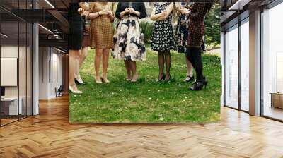 luxury stylish women toasting at elegant celebration holding champagne in restaurant terrace Wall mural