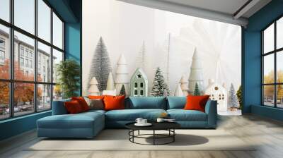 Modern christmas scene, miniature snowy village on white table. Merry Christmas! Stylish little Christmas trees and house decoration. Winter holiday banner, scandinavian monochromatic decor Wall mural