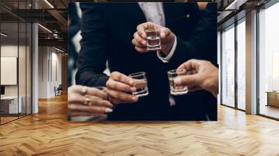 people toasting holding glasses of vodka cheering at wedding reception, celebration outdoors, catering in restaurant. christmas and new year Wall mural