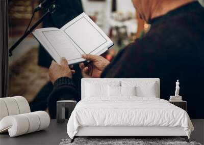 priest reading bible book in church during wedding ceremony Wall mural