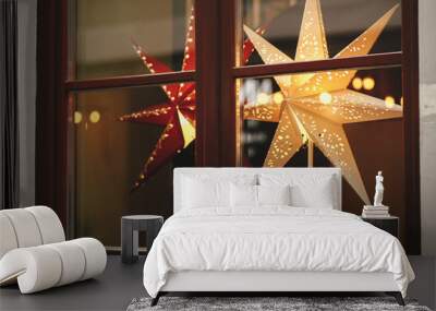 Stylish christmas stars in window, decorations of building or shops in european city street. Modern Christmas festive decor for winter holidays. Sweden illuminated stars. Merry Christmas. Magic time Wall mural