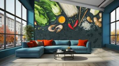 Asian cuisine ingredients over black background, top view, copy space. Flat-lay of vegetables, spices and sauces for cooking vietnamese, thai or chinese food. Clean eating, vegetarian diet concept Wall mural