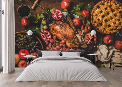 Autumn Thanksgiving, Friendsgiving, family gathering dinner. Flat-lay of Fall table with roasted duck in seasonal fruits, apple pie and red wine decorated with leaves over rusty background Wall mural