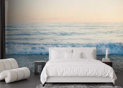 Calm Sea and pebble beach view at sunset, pastel colors Wall mural