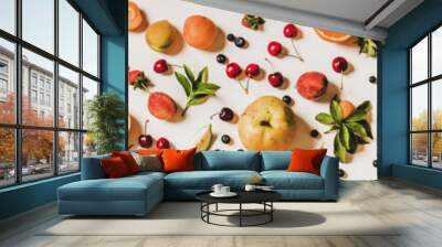 Fresh summer fruit and berries variety layout. Flay-lay of peaches, apricots, cherries, strawberries, blueberries, oranges and limes over plain white background, top view, wide composition Wall mural