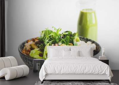 Healthy dinner or lunch. Vegan superbowl or Buddha bowl with hummus, vegetable, fresh salad, beans, couscous and avocado and green smoothie in bottle over white background, copy space, square crop Wall mural