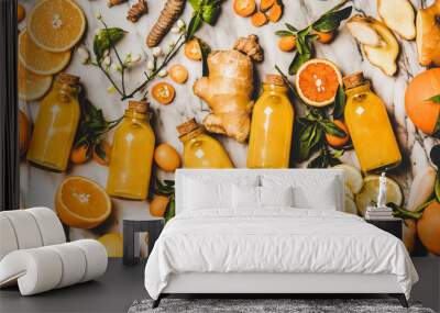 Immune boosting natural vitamin health defending drink to resist virus. Flat-lay of fresh turmeric, ginger, citrus juice shot in bottles over marble background, top view. Vegan Immunity system booster Wall mural