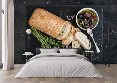 Italian ciabatta bread cut in slices on wooden chopping board Wall mural