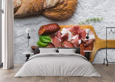 Meat plate on rustic wood board over a rough sackcloth backgroun Wall mural