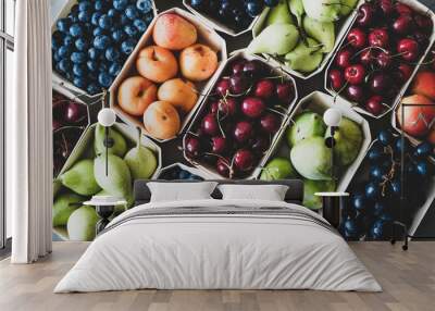 Summer fruit and berry variety. Flat-lay of ripe strawberries, cherries, grapes, blueberries, pears, apricots, figs in wooden eco-friendly boxes over grey background, top view. Local farmers produce Wall mural