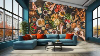 Turkish breakfast table. Flat-lay of peoples hands taking pastries, vegetables, greens, olives, cheeses, fried eggs, jams, honey, tea in copper pot and tulip glasses, top view. Middle Eastern meal Wall mural