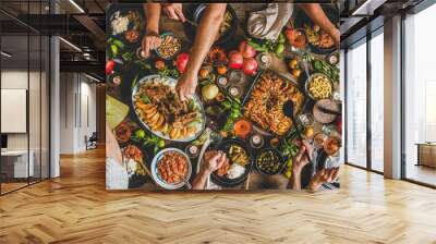 Turkish cuisine family feast. Flat-lay of peoples hands and lamb chops with quince, beans, salad, babaganush, rice pilav, pumpkin dessert, lemonade over rustic table, top view. Middle East cuisine Wall mural