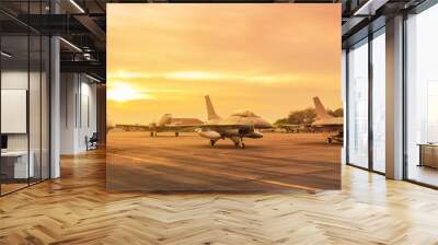 Falcon fighter jet military aircraft parked on runway in the base airforce standby ready to take off for military mission on sunset Wall mural