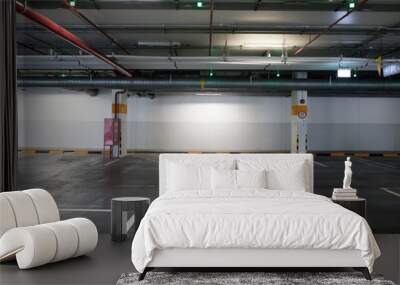 vacant indoor  parking lot on basement showing electricity and water pipe on ceiling and safety equipment Wall mural