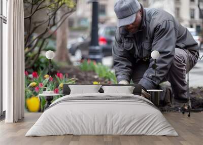 Gardener planting spring flowers at city hall Wall mural