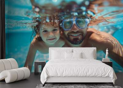 Father & daughter swimming underwater in a pool on summer vacation. Googles water action shot. Happy family on holiday. Learning to swim. Blue Father's day banner concept Wall mural