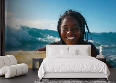 Happy african american girl surfing in the ocean. Smiling black female surfer on a yellow surfboard in the sea. Candid female swimming on vacation. Blue sky, water, summer beach holiday. Copy space Wall mural