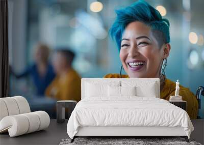 Inclusive image of happy gay female employee with blue hair sitting in a wheelchair in diverse & accessible dei workplace. Pride month business marketing inclusion concept. Wall mural