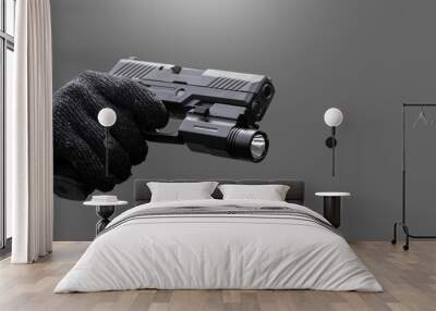 Isolated 9mm pistol gun holding in right hand of gun shooter with clipping paths, copy space. Wall mural