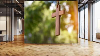 Wooden cross hanging on tree branch, soft and selective focus, natural bokeh tree background, concept for hope, love, forgiveness and belief in Jesus around the world. Wall mural