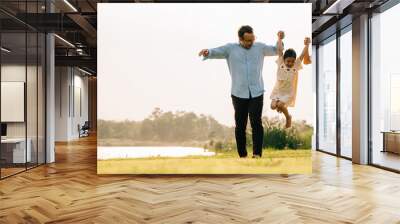 A group of cheerful people walking and having fun together in a beautiful nature setting on a sunny day, feeling the beauty and the energy of the outdoors, Happy family day Wall mural