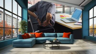 Asian hard senior businessman working with laptop computer has a problem with back pain. Old man feeling pain after sitting at desk long time, Healthcare and medicine office syndrome concept Wall mural