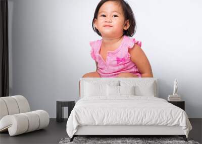 Asian little cute baby child girl education training to sitting on blue chamber pot or potty with toilet paper rolls, studio shot isolated on white background, wc toilet concept Wall mural