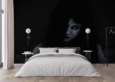 Asian woman ghost or zombie horror creepy scary close up she face and hair covering the face her eye looking to camera at night, Halloween day concept, in dark tone Wall mural