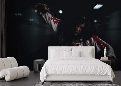 Bloody halloween makeup. Horror bloodthirsty ghost girl hair covering face and eye reach arm out, Asian woman zombie with blood she death and scary at night in tunnel, Happy halloween day concept Wall mural