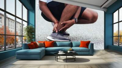 Close up Asian young sport runner black man wear watch hands joint hold leg pain because of twisted ankle broken while running at the outdoor street health park, healthy exercise Injury from workout Wall mural