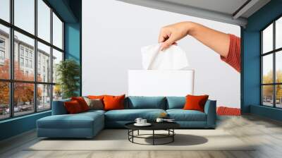 Young woman flu she using hand taking pulling white facial tissue out of from a white box for clean handkerchief, studio shot isolated on white background, Healthcare medicine concept Wall mural