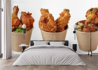 Delicious crispy golden brown fried chicken in paper bucket served on white background Wall mural