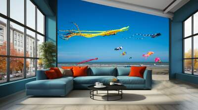 Flying kite  festival with Octopus,jellyfish,fish and shaped animal.Various colorful kites flying in the blue sky on the public beach. Wall mural