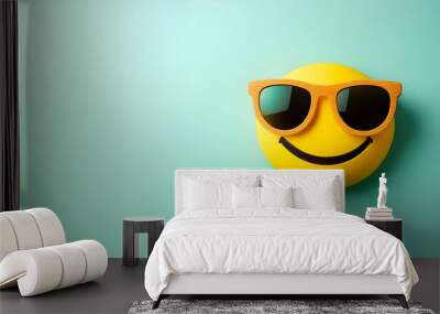 A cheerful smiley face wearing stylish sunglasses against a blue background, radiating joy and positivity. Wall mural