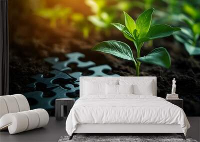 A vibrant green plant growing from rich soil, accompanied by black puzzle pieces, symbolizing growth and connection. Wall mural