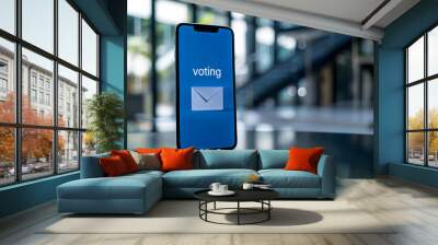 Smartphone displaying voting screen with an envelope icon, representing online or mobile voting, in a modern office setting. Wall mural