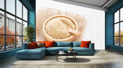 brown sugar and wood spoon in brown bowl on white wooden table Wall mural