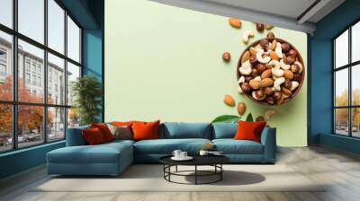 Assortment of nuts in wooden bowl on colored table. Cashew, hazelnuts, walnuts, almonds. Mix of nuts Top view with copy space Wall mural