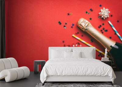 bottle of champagne with glasses and colorful confetti on colored background. top view flay lay Wall mural