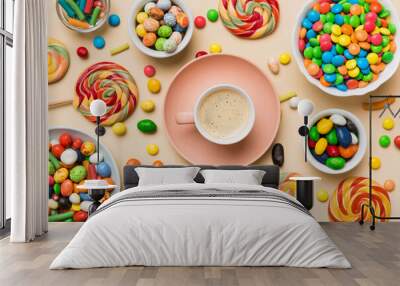 Coffee cup with chocolates and colored candy. Top view on table background with copy space Wall mural