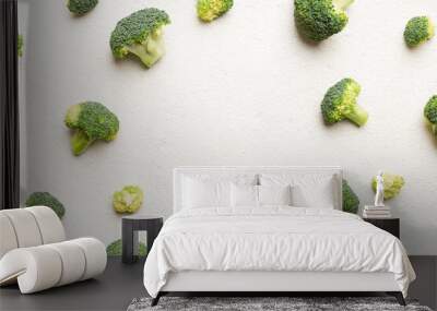 Flat lay composition with fresh green broccoli frame eith copy space on light background Wall mural