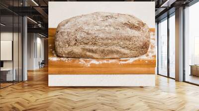 Freshly baked bread on cutting board against white wooden background. perspective view bread with copy space Wall mural