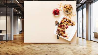 Healthy breakfast food with granola, yogurt, fruits and nuts. Dessert parfait with dried fruits for breakfast Wall mural